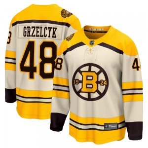 Youth Fanatics Branded Boston Bruins Matt Grzelcyk Cream Breakaway 100th Anniversary Jersey - Premier